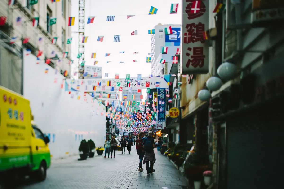 Colorful flags adorn Namdaemun Market street in Seoul, South Korea.