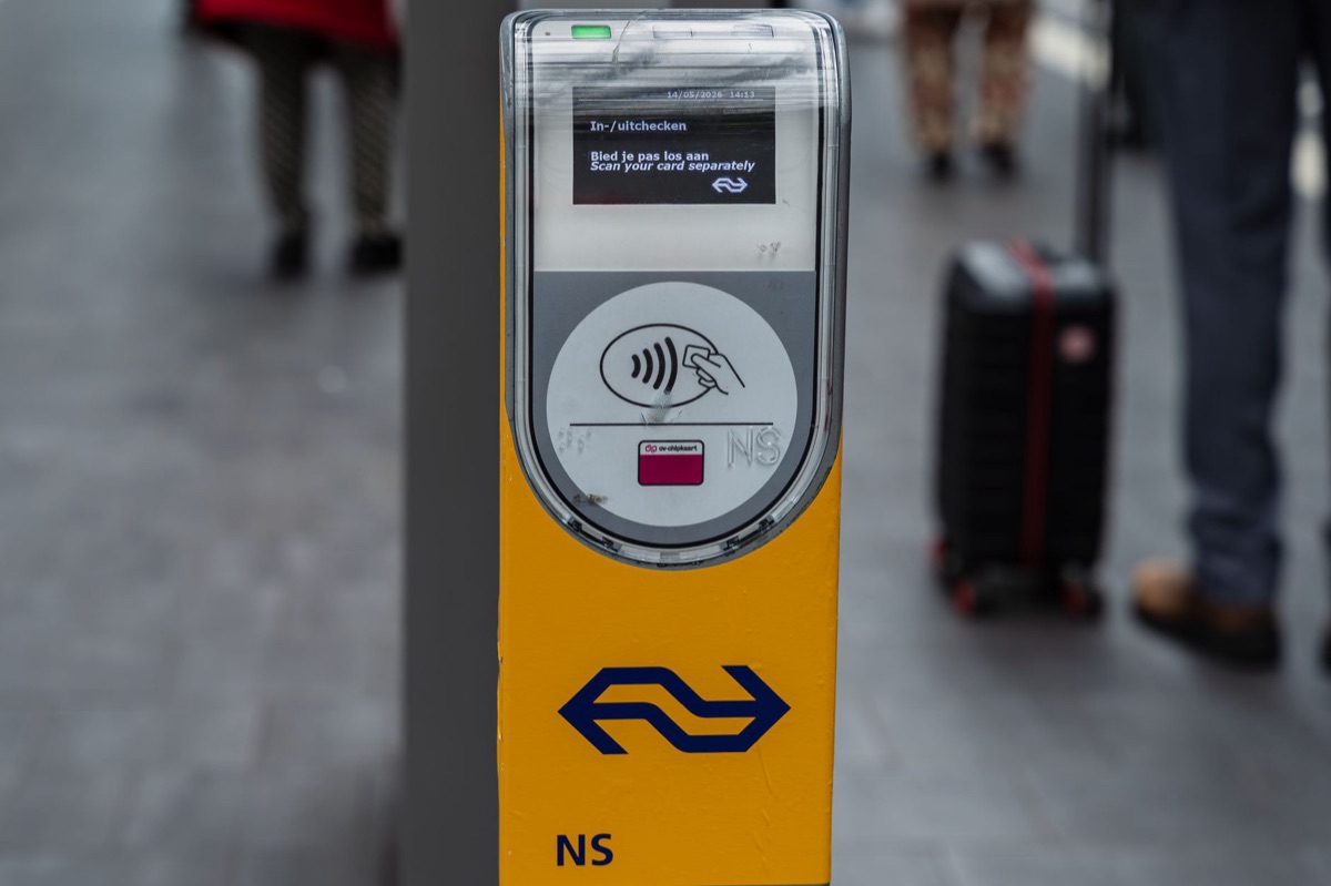 A person using a smartphone to book a train ticket